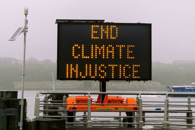 traffic sign reads "End Climate Injustice"