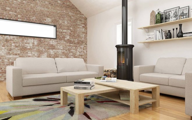 two beige sofas near a small wood-burning stove