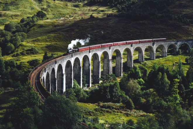 train traveling through rolling green hills