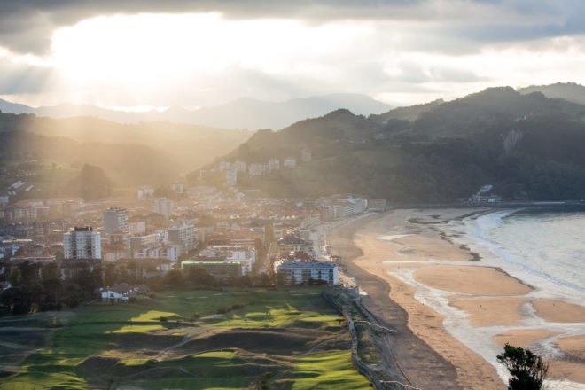 landscape photo of city, beach, farmland and mountains