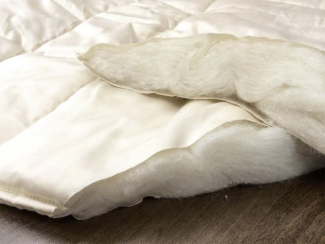 wool comforter on wooden surface