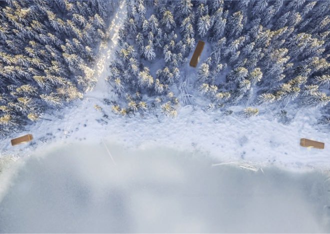 aerial rendering of long rectangular cabins in snow-covered forest