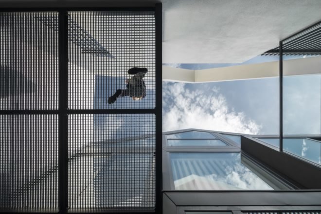 worm's eye view of person walking on metal perforated floor