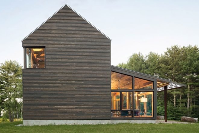 gray wood home with gabled roof and sun room