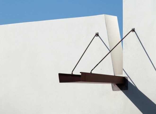 a walkway that leads out from an all white wall