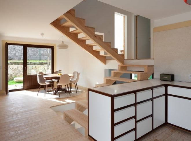 interior space with white cabinets and stairs leading to second floor