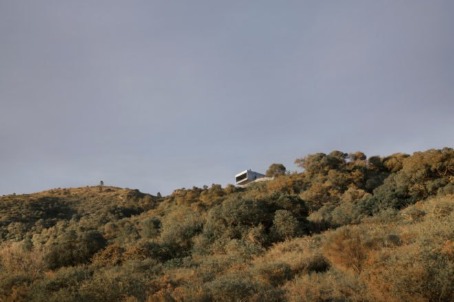 a rectangular home on a mountainside