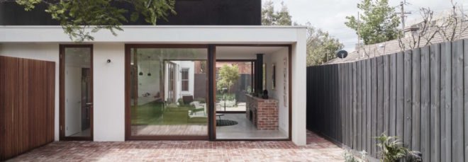 large glass windows fill the entrance of the home