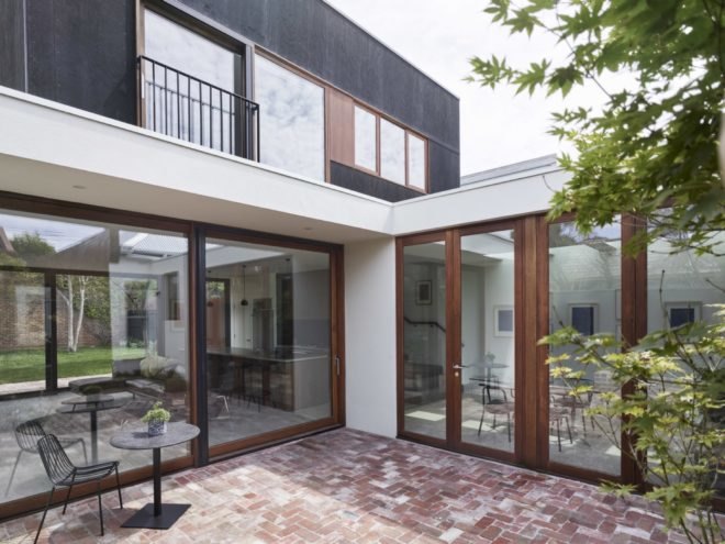 brick patio floor adorn the home's outdoor space with large windows throughout the home