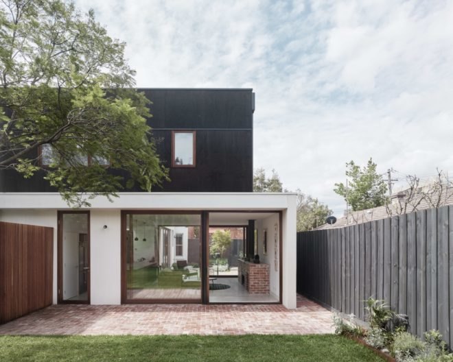 large glass windows fill the entrance of the home