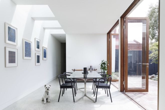 dining area with white walls and black table and chairs