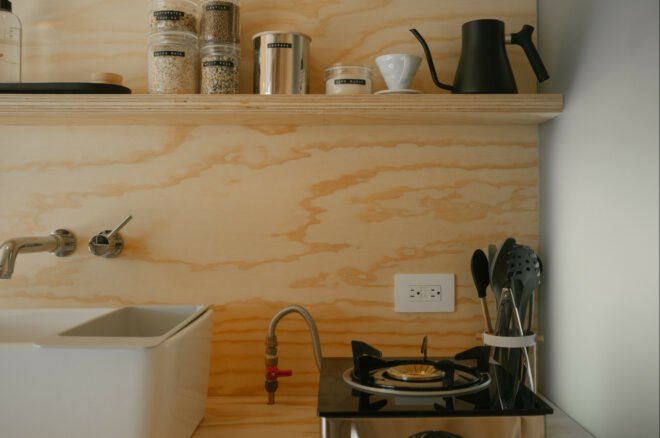 wooden kitchen with white sink and burners