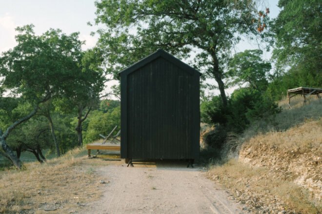 Black tiny cabin on gravel path