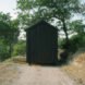 Black tiny cabin on gravel path