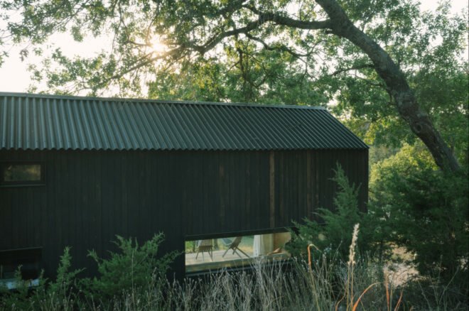all-black tiny cabin with windows