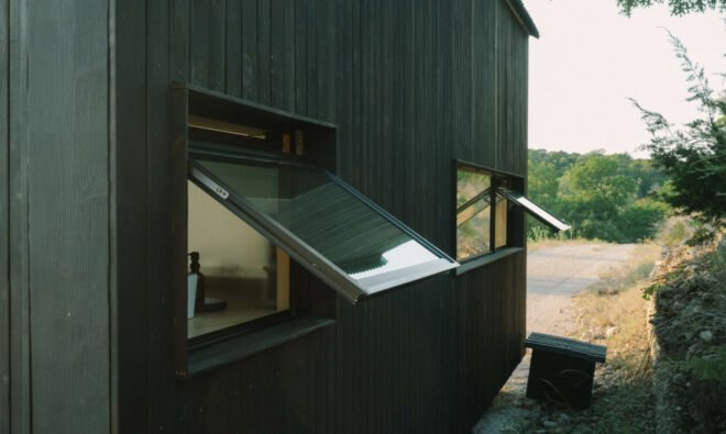 all-black tiny cabin with windows