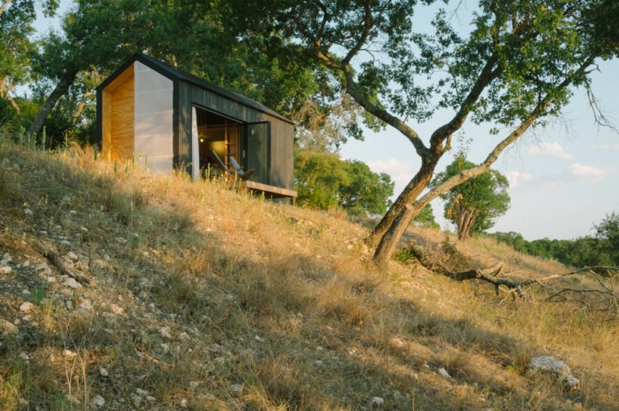 Black tiny cabin on hilltop