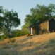 Black tiny cabin on hilltop