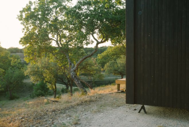 corner of black cabin with seating area in front