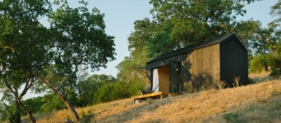 Black tiny cabin on hilltop