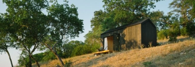 Black tiny cabin on hilltop