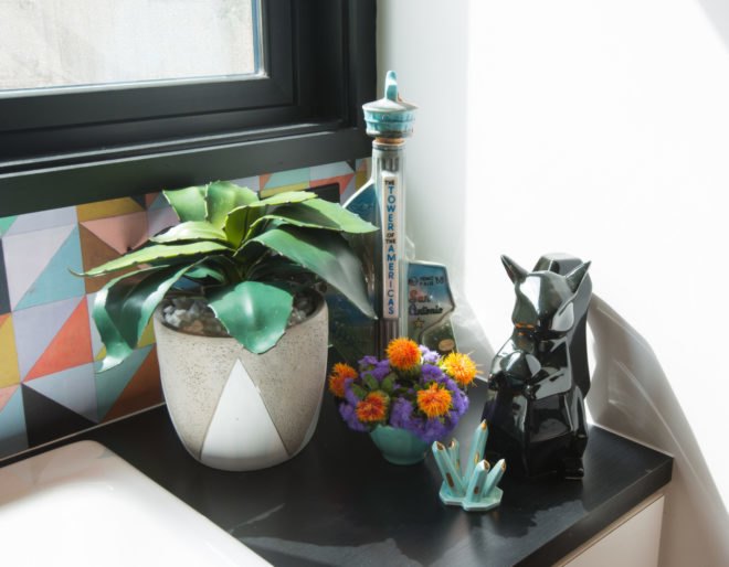 a small table with a plant and knicknacks