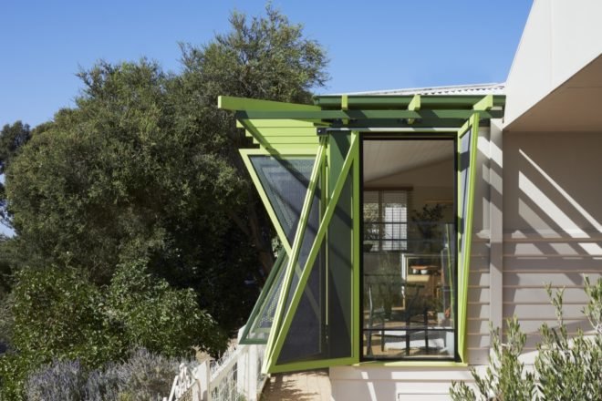 view of open shutters from a side angle with a view of the interior dining area