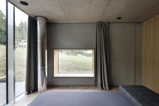 gray room with chevron wood floors and large windows