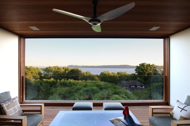 covered outdoor patio with gray seats and views of Hudson River