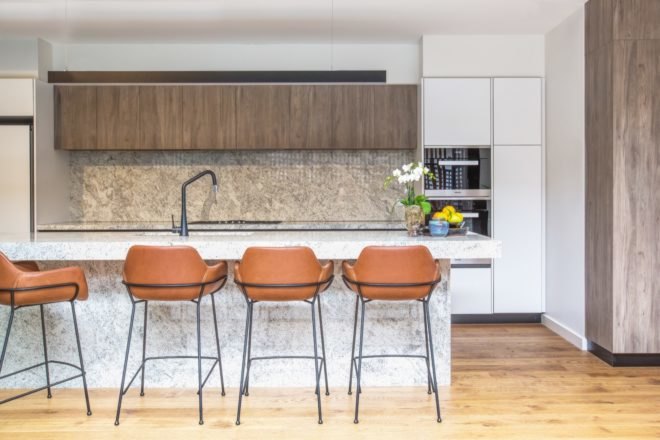 kitchen with marble island and dark wood cabinets