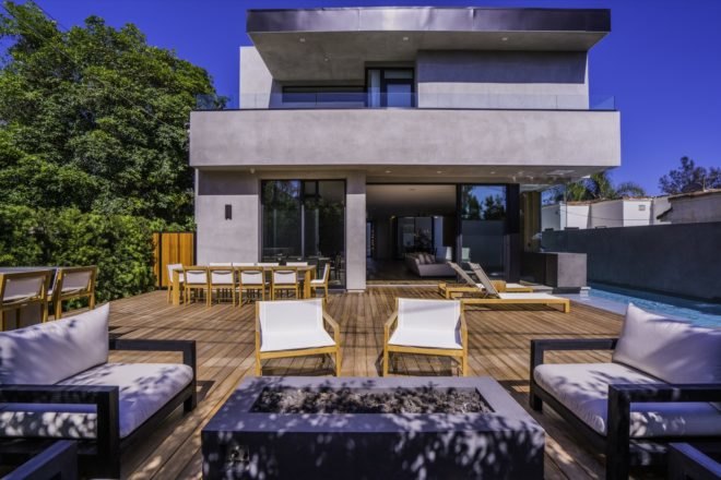 lounge chairs on outside deck near fire pit by the pool