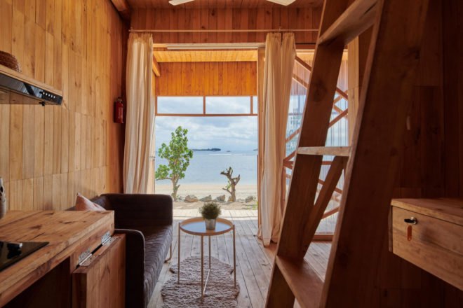 room with a large open view of the beach