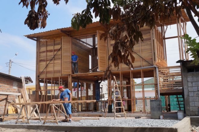 people constructing a wood structure