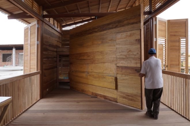person carrying large slab of wood