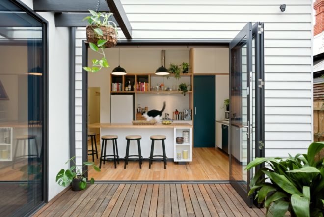 glass door open to wooden kitchen island
