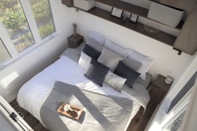 bed with white and grey pillows and blankets