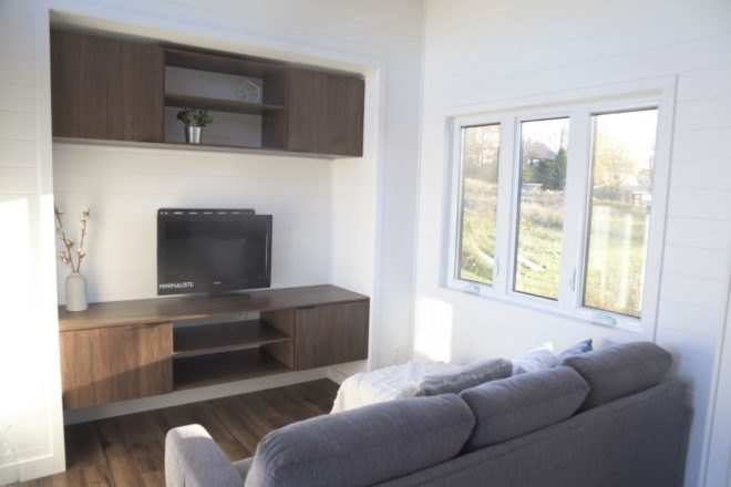 view of living space with grey sofa and entertainment center