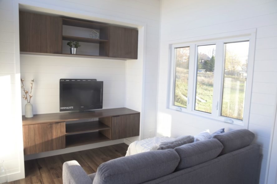 view of living space with grey sofa and entertainment center