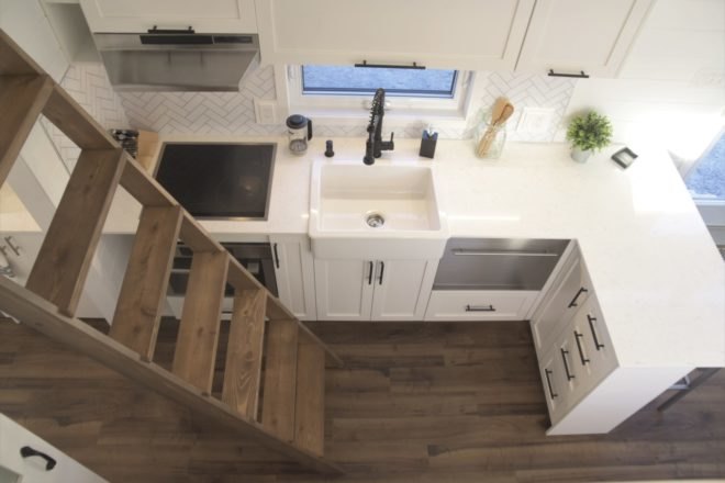 A wooden ladder leads up to a sleeping loft