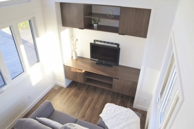 view of living space with grey sofa and entertainment center