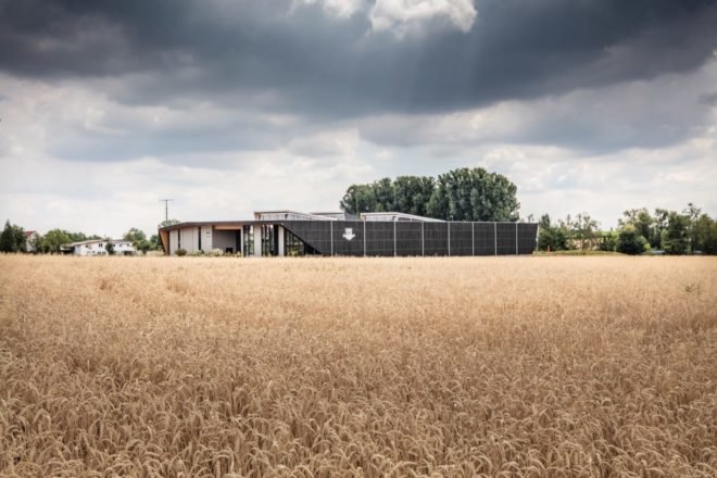 dark timber building on a farm