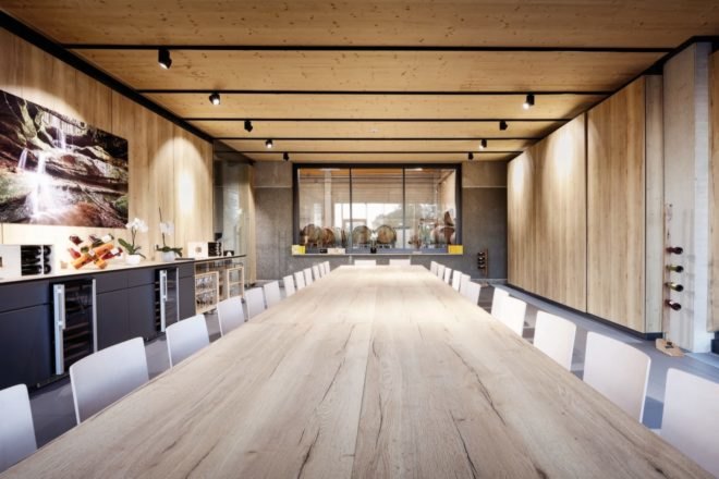 wood-lined meeting room with long wood table