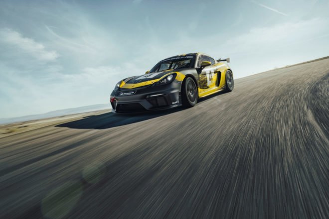 exterior of black and yellow porsche cayman on race track