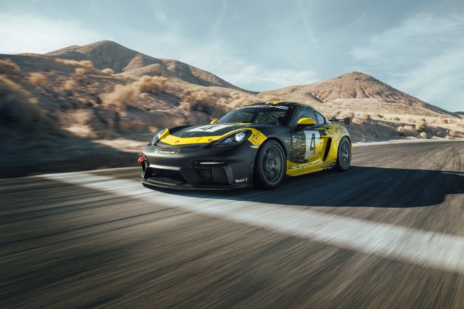 exterior of black and yellow porsche cayman on race track