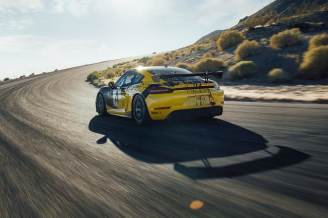 exterior of black and yellow porsche cayman on race track