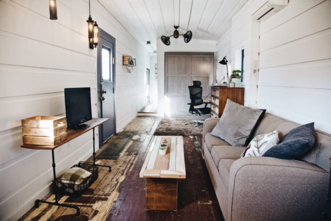 large living space with white walls and a tan sofa
