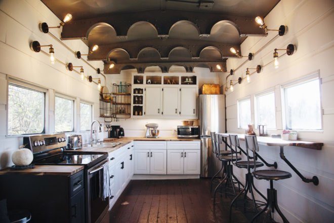 large kitchen space with white cabinets and dark wood floors