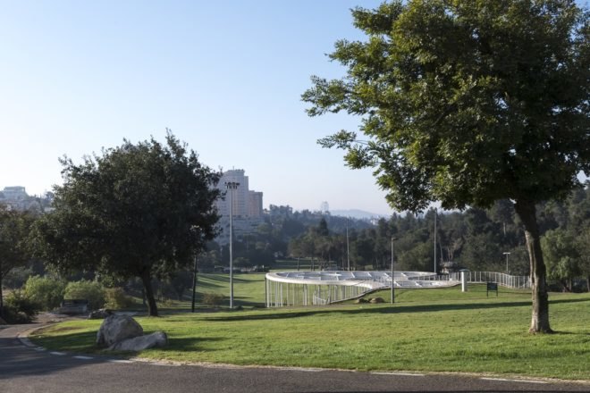 view of the cafe with building in the distance nearby the park