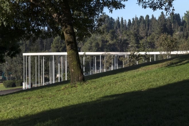 cafe's modern design surrounded by greenery and trees in park