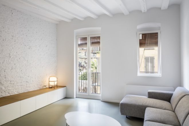 view of the living room with white walls and tall windows